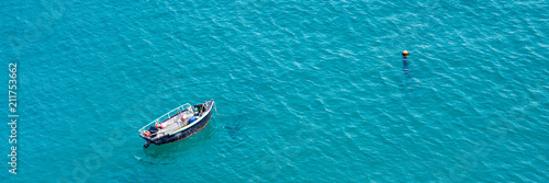 Small boat on the sea, panoramic aerial view,  in Guernsey © Delphotostock