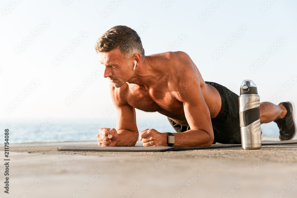 Motivated shortless sportsman in earphones Motivated shortless sportsman in earphones