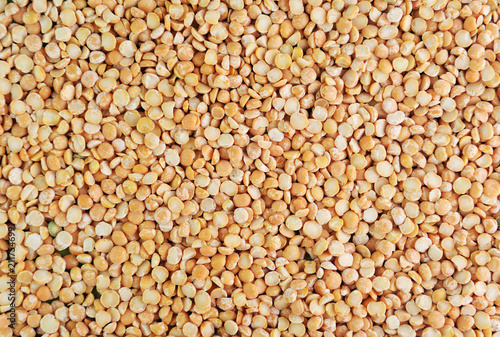 Yellow split peas (cereals).Dry yellow split peas background texture, vegetable protein source fo vegetarians and vegans