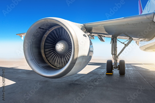 Wing jet engine of the airplane at the airport apron.