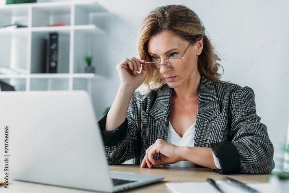 attractive businesswoman working in office with notebook and laptop attractive businesswoman working in office with notebook and laptop