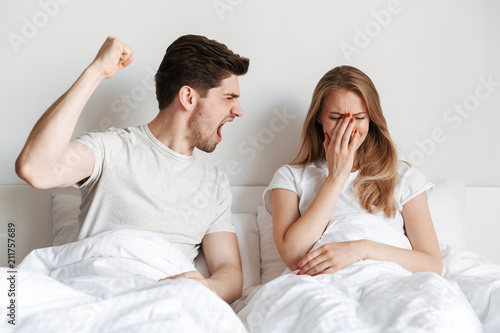 Angry negative man screaming on his offended wife
