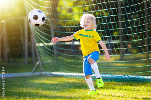 Brazil football fan kids. Children play soccer. © famveldman