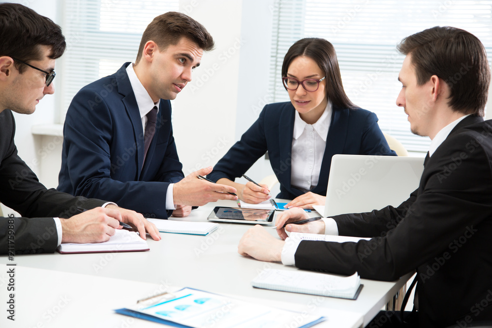 Businessman explains to colleagues a new project Businessman explains to colleagues a new project