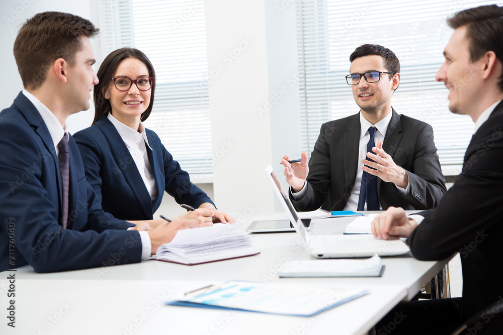 Business people are sitting around the table at a meeting in the office Business people are sitting around the table at a meeting in the office