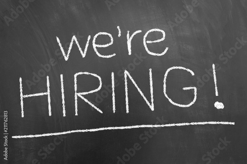 We are hiring announcement chalk text on blackboard or chalkboard.