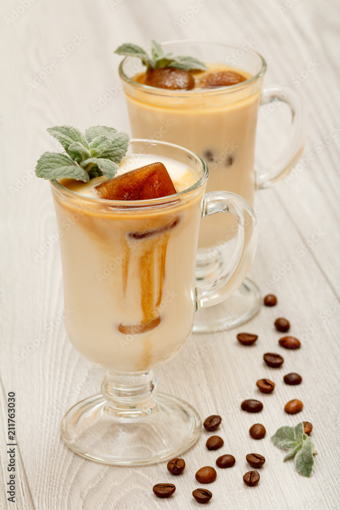 Two glasses of delicious milkshake (smoothie) with chocolate ice and leaves of mint Two glasses of delicious milkshake (smoothie) with chocolate ice and leaves of mint