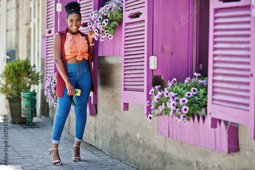 African american girl posed against purple windows outdoor. photo