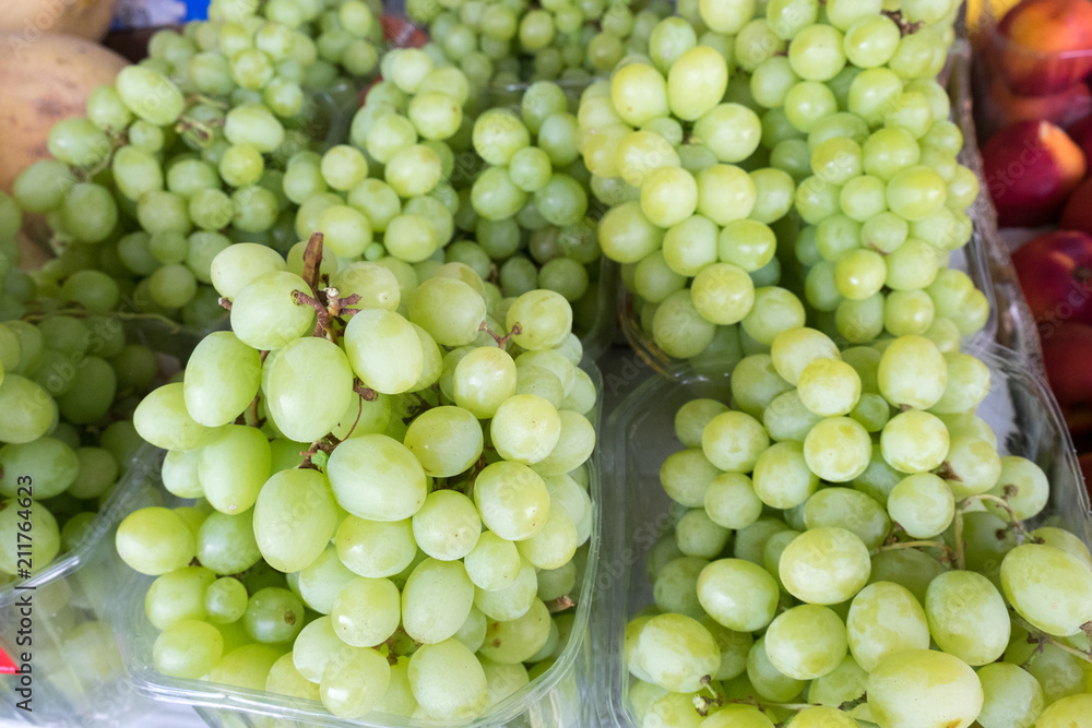 Macro shot of new harvest green-yellow grapes for sale at local farmers market Macro shot of new harvest green-yellow grapes for sale at local farmers market