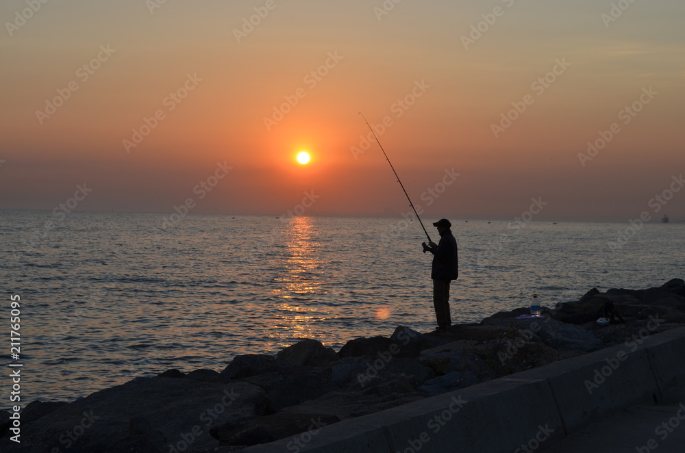fishing sunset sea man fishing rod