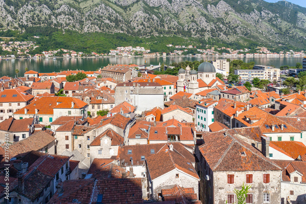 View from above on the old historical city Kotor with orange tile roofs, boka-kotor bay and mountains at Adriatic sea coastline, Montenegro