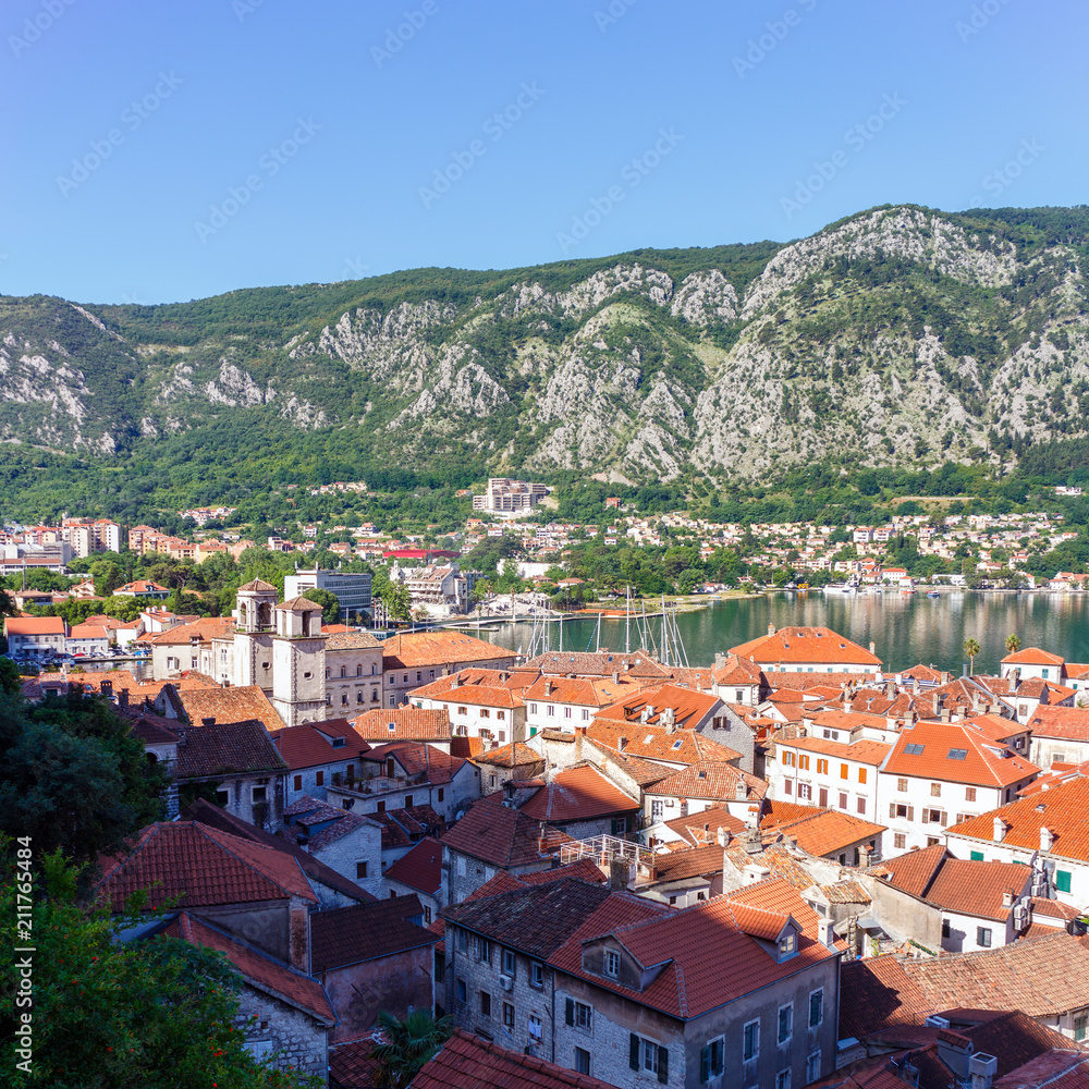 View from above on the old historical city Kotor with orange tile roofs, boka-kotor bay and mountains at Adriatic sea coastline, Montenegro