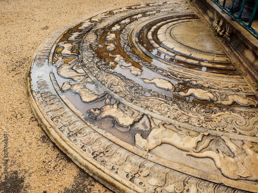 The artistic ancient moonstone in Anuradhapura ancient city, Sri Lanka. It is the carved semi-circular stone slab, placed at the bottom of staircases and entrances of the temple.