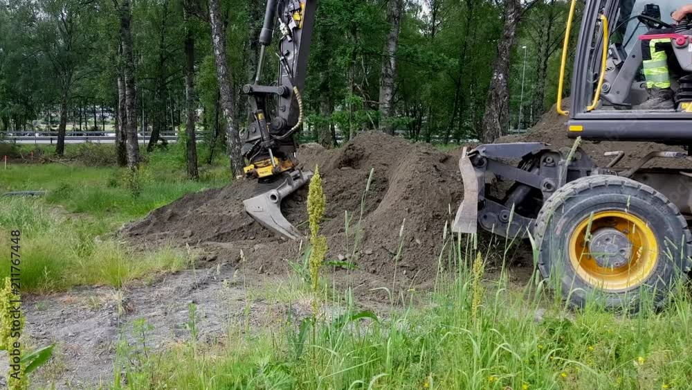 An excavator digs, and cleans the land from dirt. An excavator digs, and cleans the land from dirt.