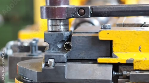 Bending the pipes in the factory. Pipe bending machine.