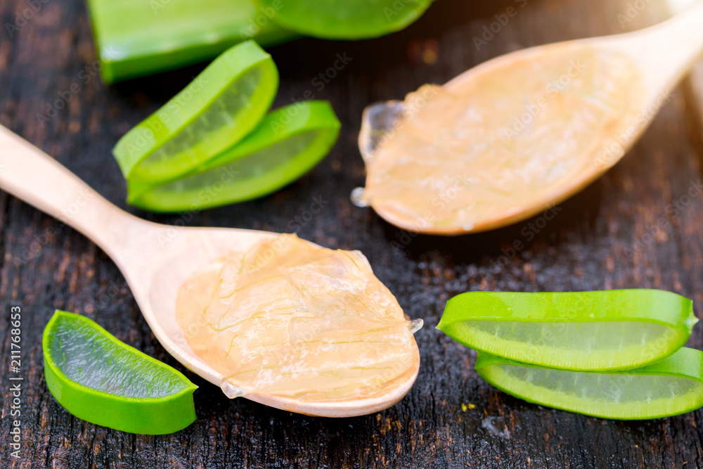 Aloe vera on wooden spoon on wooden table There are many useful herbs. Aloe vera on wooden spoon on wooden table There are many useful herbs.