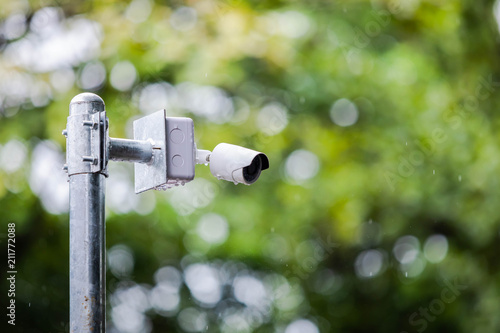 CCTV camera mounted on a pole with natural blurry background