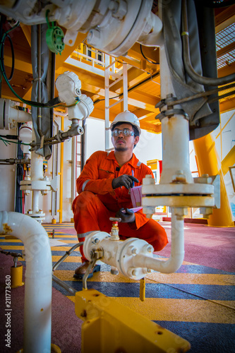 operator recording operation of oil and gas process at oil and rig plant, offshore oil and gas industry, offshore oil and rig in the sea, operator monitor production process, routine daily record.