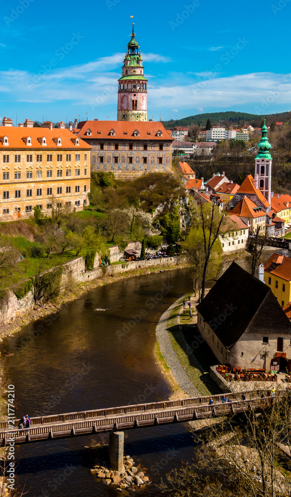 Cesky Krumlov. Beautiful aerial view at castle tower, red roofs of the old town center and Vltava river. Landmarks of Bohemia, Czech republic