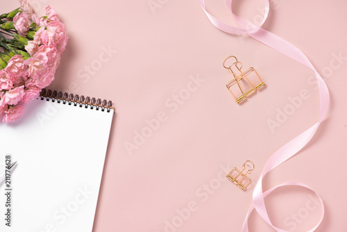 Top view note book anf flowers on the desktop. For wedding planner concept