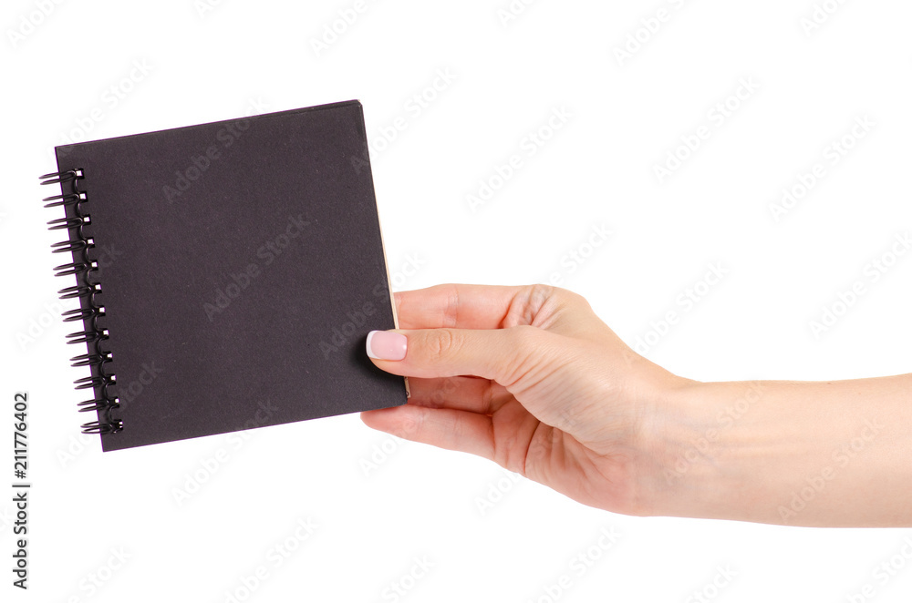 Notepad with black paper in hand on white background isolation Notepad with black paper in hand on white background isolation