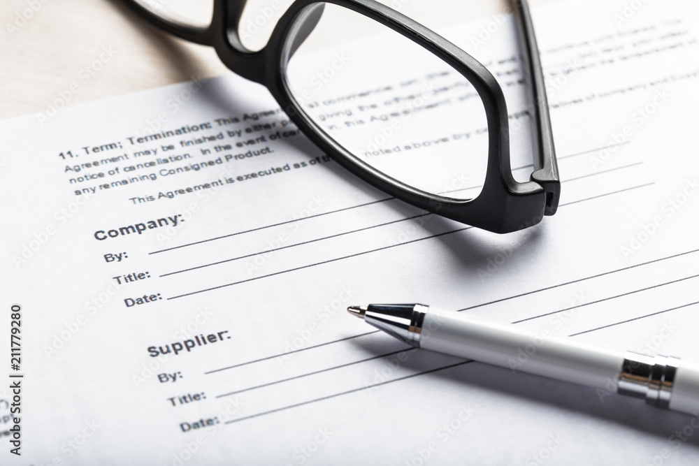 Close up shot of Eyeglasses on document papers business concept Close up shot of Eyeglasses on document papers business concept