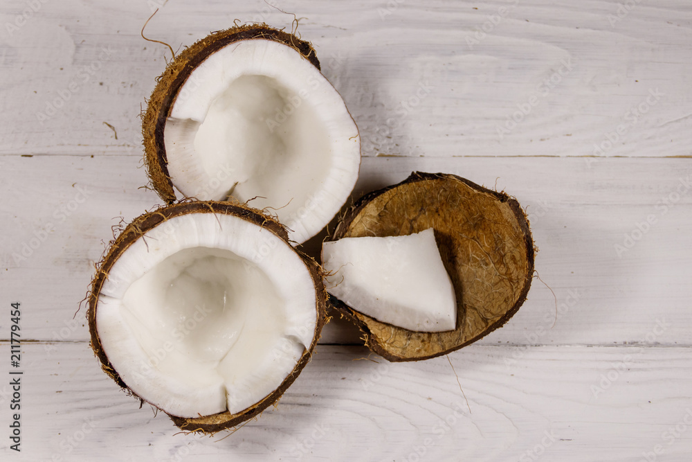 Fresh ripe coconut on white wooden table Fresh ripe coconut on white wooden table