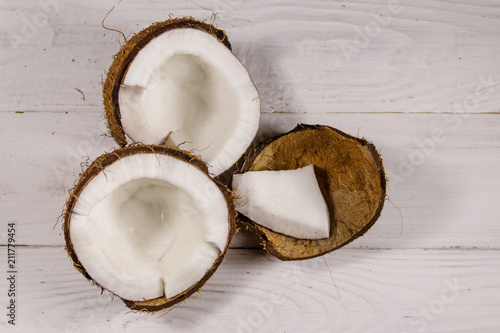 Fresh ripe coconut on white wooden table