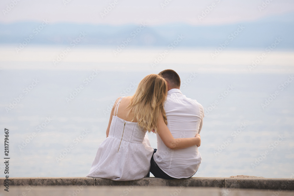 Couple Sitting at Lake