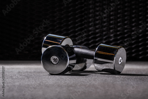 Two dumbbels with steel background in sportclub, weight 10 kg - kilograms 