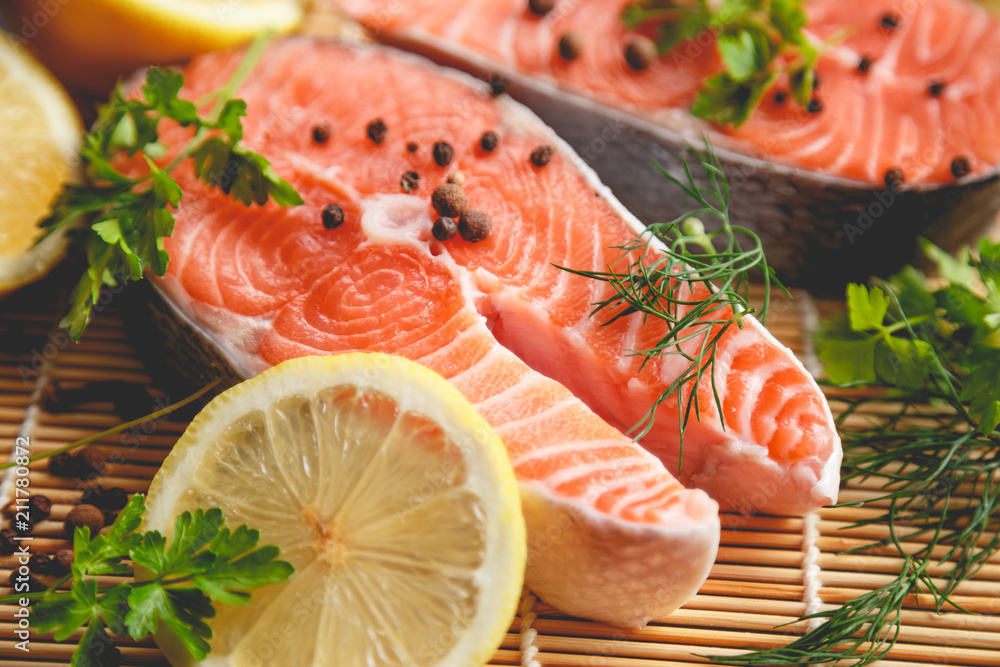 Salmon steaks with lemon and spices close up view. Salmon steaks with lemon and spices close up view.