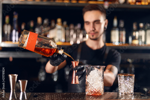 Bar. Bartender Making Cocktails  Measuring Alcohol