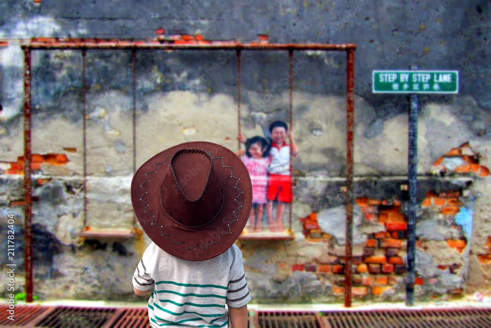 Fototapeta premium Dziecko na ulicy, Penang Mural, Sztuka ulicy w Penang