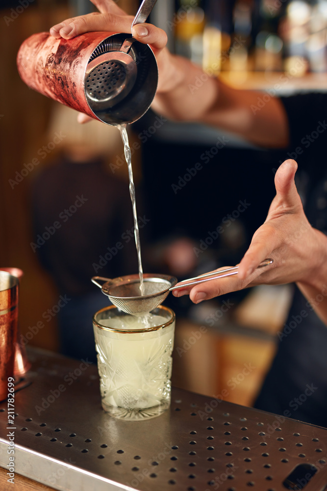Cocktail Bar. Bartender Making Cocktails, Pouring Drink In Glass