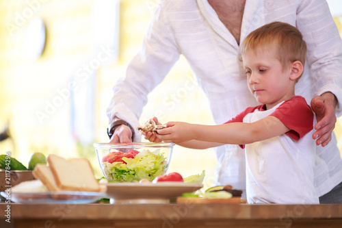Photo of man and son preparing salad