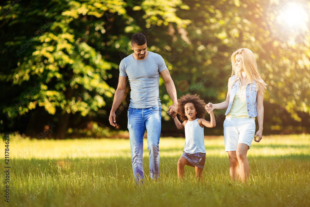 Fototapeta premium Happy young couple spending time with their daughter