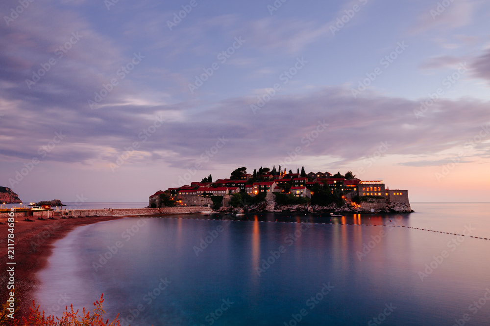 Sveti Stefan island in Montenegro, sunset on the seacoast. Popular travel destination.