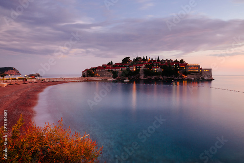 Beautify view on Sveti Stefan island, sea and coastline in Montenegro in the sunset. Popular travel destination. © Yury
