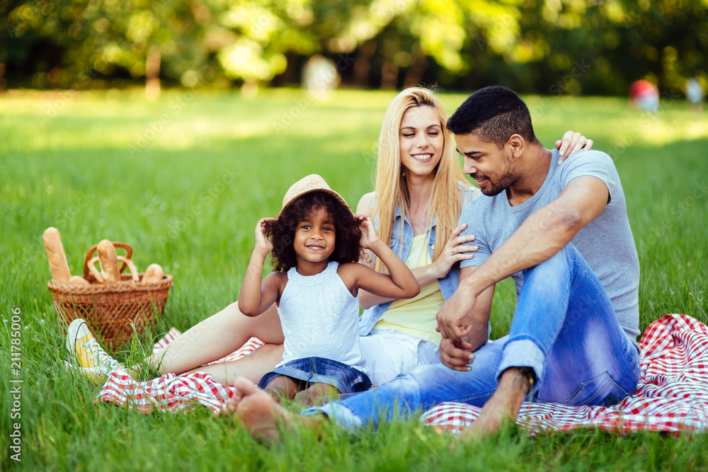 Picture of lovely couple with their daughter having picnic Picture of lovely couple with their daughter having picnic