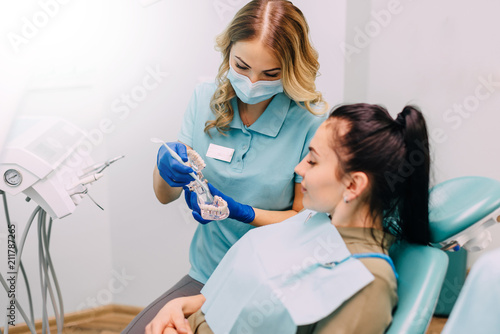 young woman patient consults female dentist at dental clinic