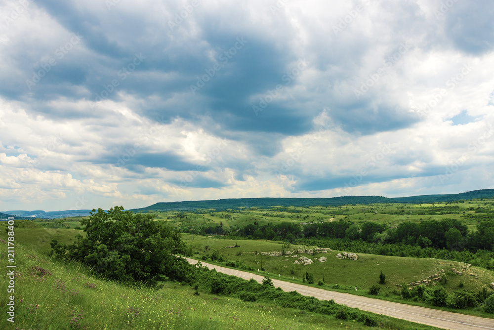 Fototapeta premium Road between green hills and