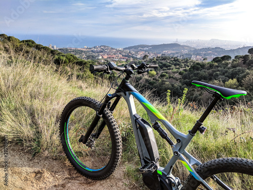 Photography Closeup of an ebike parked on a single track path just before dawn, near Barcelo