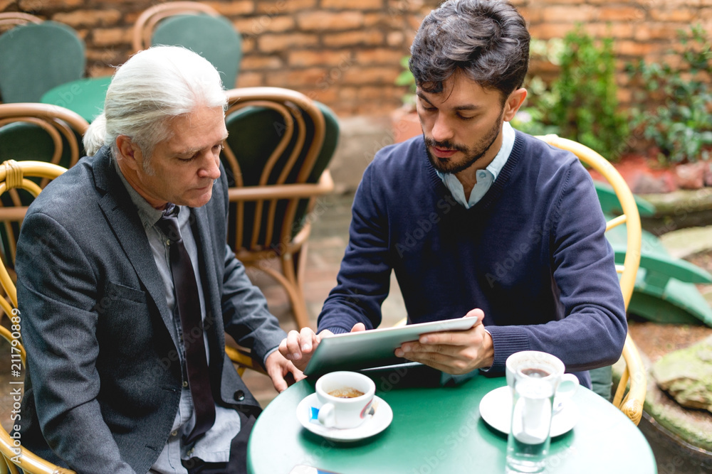 Two colleagues have a meeting in the cafe Two colleagues have a meeting in the cafe