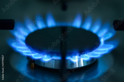 A view of the gas stove in daylight in a kitchen. Blue flame of natural gas. Natural energy. Liquefied natural gas.