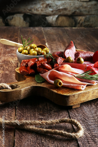Marble cutting board with prosciutto, bacon, salami and sausages
