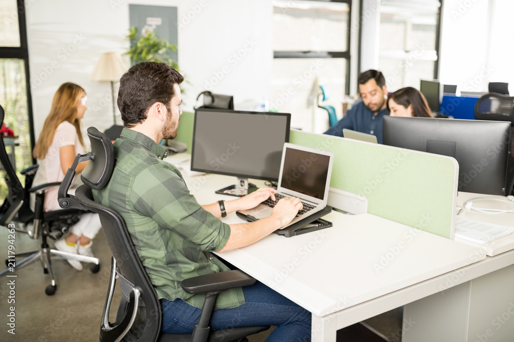 Software developer working at his desk Software developer working at his desk