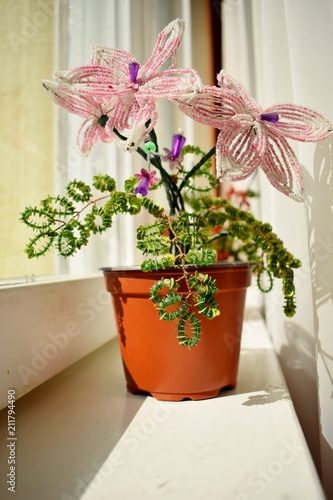 beautiful pink flower of beads on the window-sill