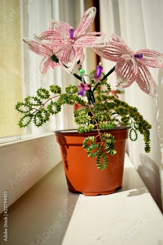 beautiful pink flower of beads on the window-sill