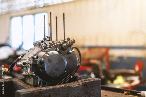 motorcycle repair with soft-focus and over light in the background photo