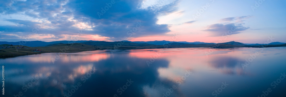 Beautiful panoramic view of the Lake on the sunset and hills on the background